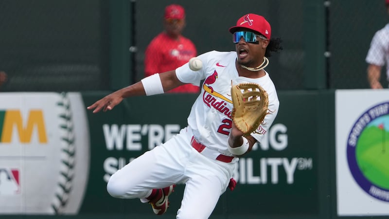 St. Louis Cardinals right fielder Jose Barrero slides to catch a fly ball by Washington...