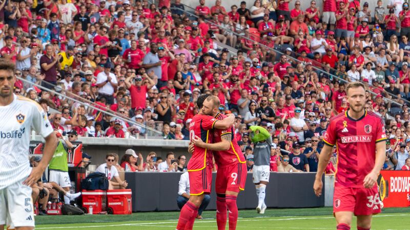 Midfielder Eduard Löwen embraces forward João Klauss as he makes his return to the pitch for...