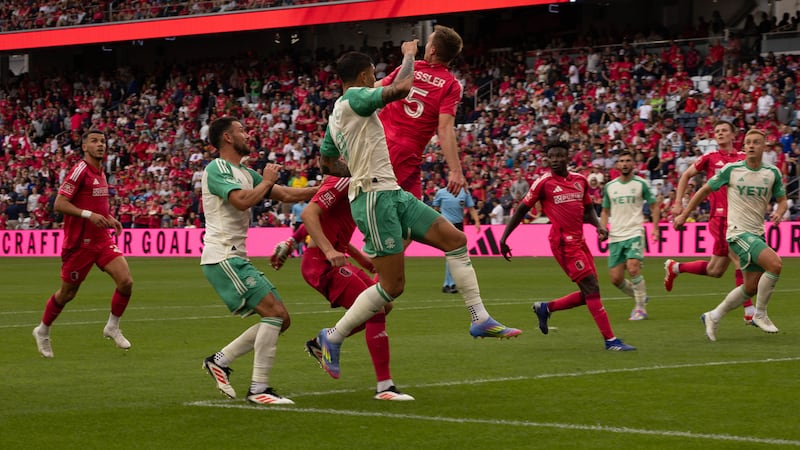 St. Louis CITY SC's Henry Kessler leaping to defend among several Austin FC players.