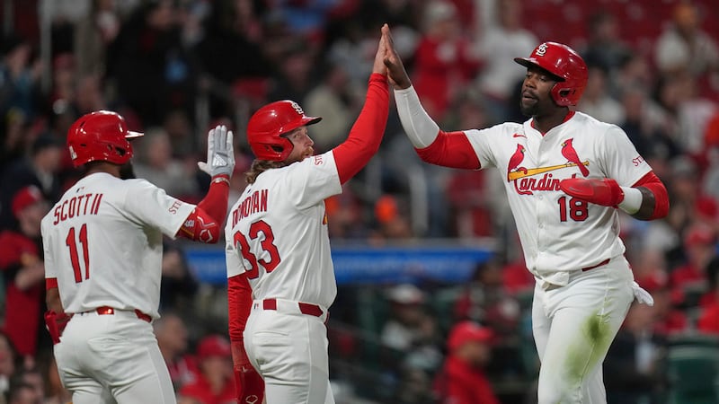 St. Louis Cardinals' Jordan Walker (18) is congratulated by teammates Brendan Donovan (33) and...