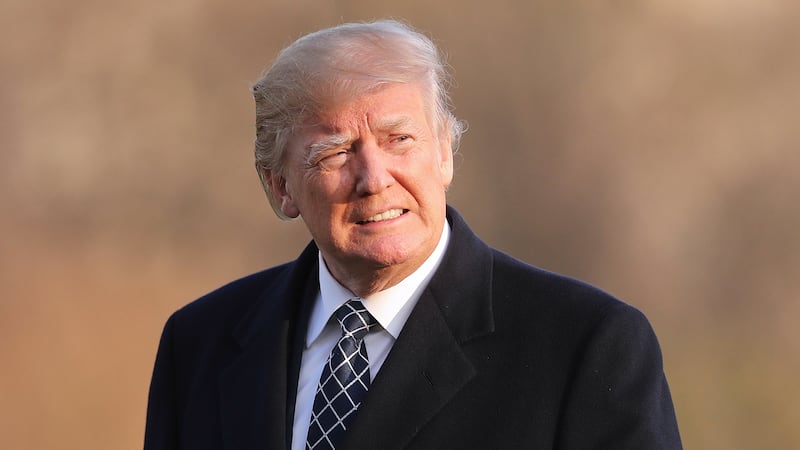 FILE - President Donald Trump walks across the South Lawn of the White House in Washington,...