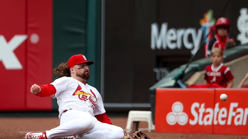 St. Louis Cardinals' Ryan Vilade is unable to catch a foul ball hit by Kansas City Royals'...