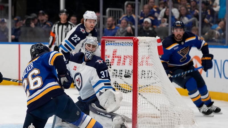 FILE PHOTO - St. Louis Blues' Nathan Walker (26) scores past Winnipeg Jets goaltender Connor...