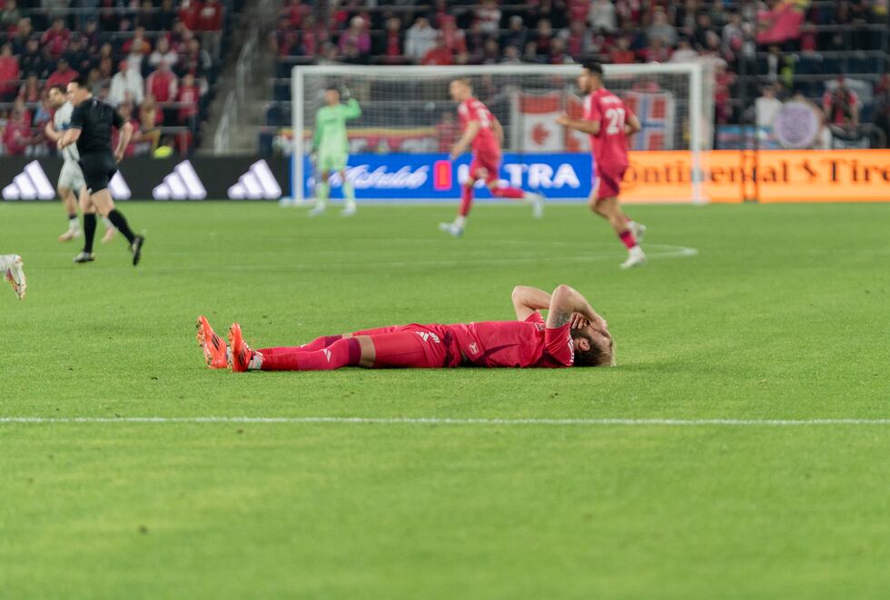 João Klauss lying in pain after getting clipped in the head by a Vancouver defender during a...