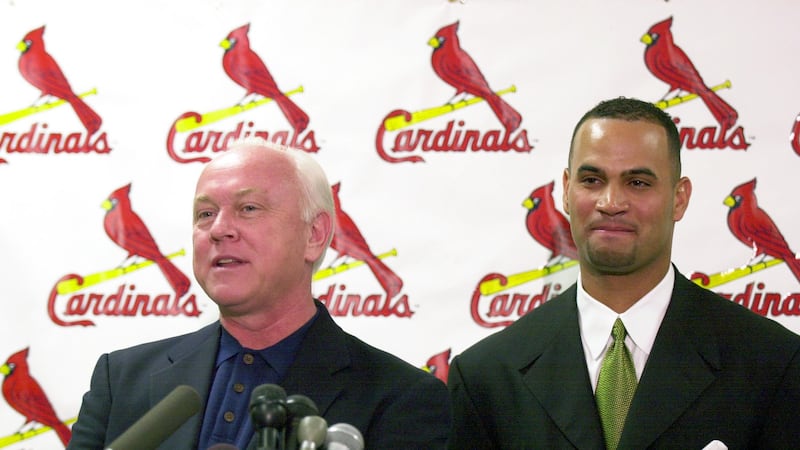 FILE - St. Louis Cardinals general manager Walt Jocketty, left, introduces Albert Pujols after...