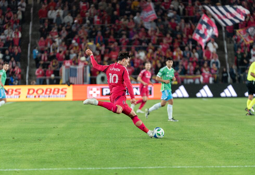 Midfielder Eduard Löwen strikes the ball in a match against Seattle Sounders FC.