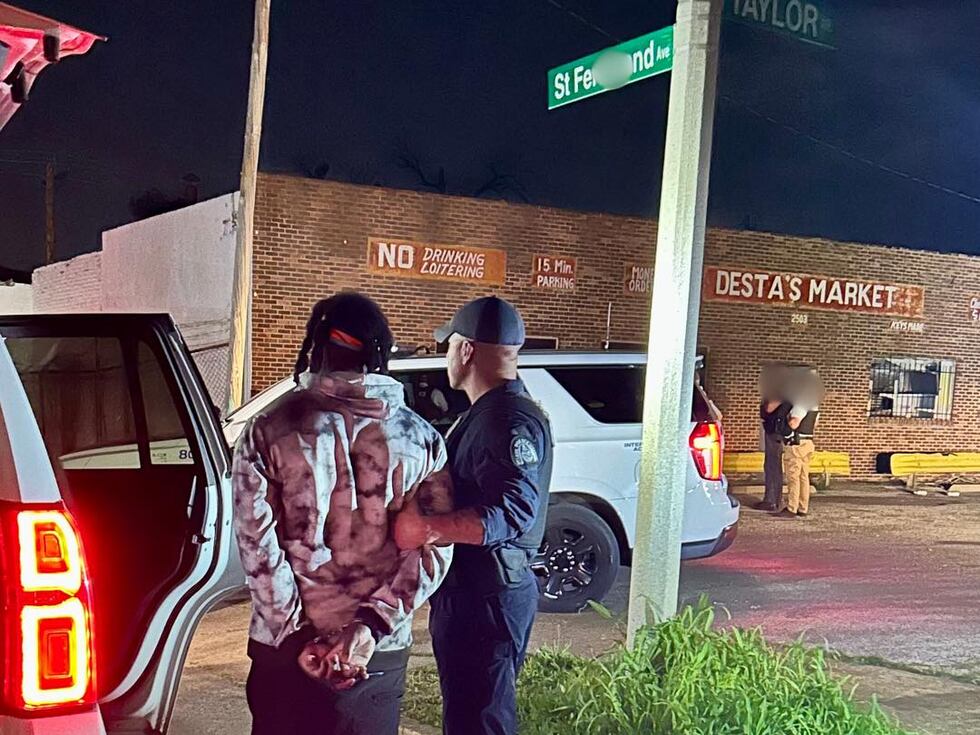 St. Louis Metropolitan handcuff a suspect following what the agency says was a looting...