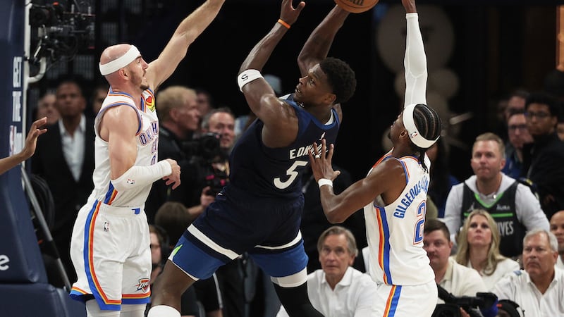 Minnesota Timberwolves guard Anthony Edwards (5) looks to the ball between Oklahoma City...