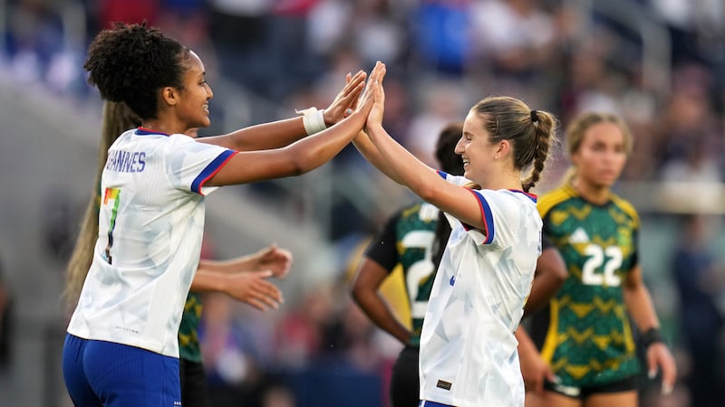 United States' Ally Sentnor, right, is congratulated by teammate Lily Yohannes after scoring...