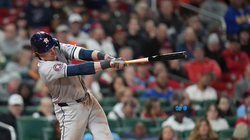Houston Astros' Jake Meyers hits an RBI single during the sixth inning of a baseball game...