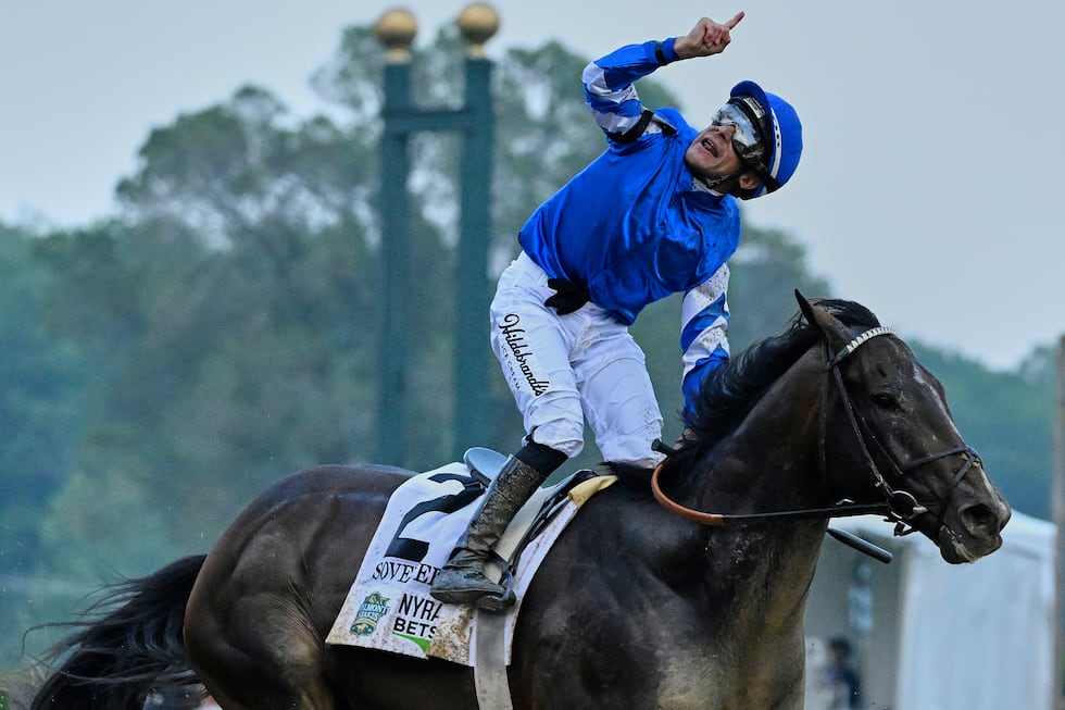 Jockey Junior Alvarado reacts aboard Sovereignty (2), after crossing the finish line to win...