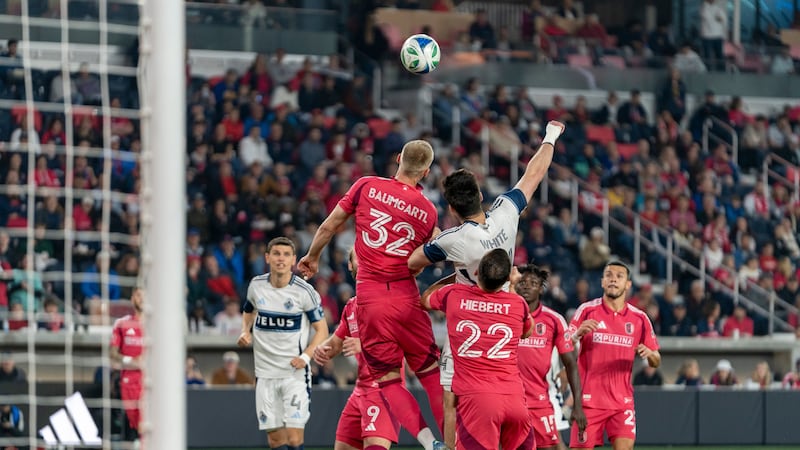 Timo Baumgartl challenges Vancouver's Brian White for a header.