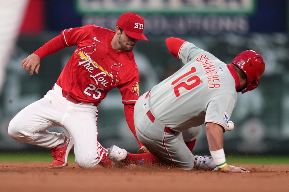 Philadelphia Phillies' Kyle Schwarber (12) is safe at second for a stolen base as the throw...