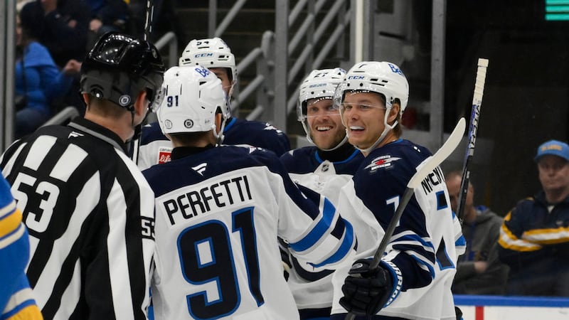 Winnipeg Jets left wing Nikolaj Ehlers, center, is congratulated by teammates after scoring a...