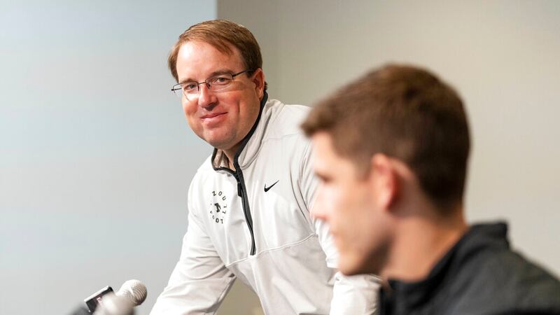 Missouri head football coach Elias Drinkwitz, left, looks at his new offensive coordinator,...