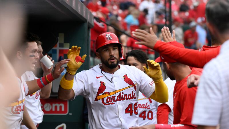 St. Louis Cardinals' Iván Herrera is congratulated in the dugout by teammates after hitting a...