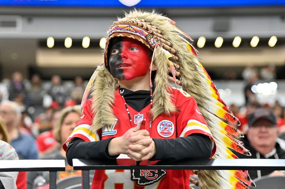 FILE - A young Kansas City Chiefs fan, dressed with a headdress and face paint, looks on...