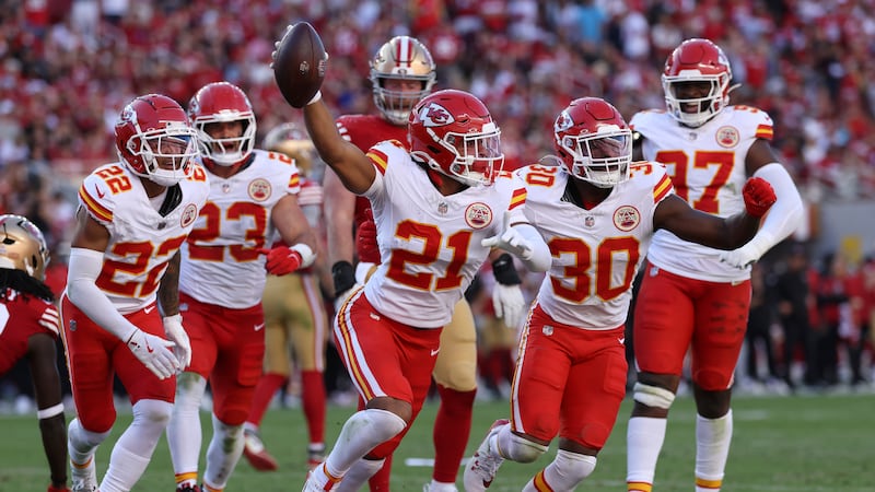 Kansas City Chiefs safety Jaden Hicks (21) celebrates with teammates after intercepting a ...