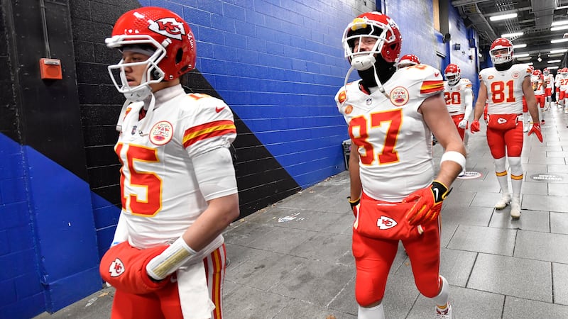 Kansas City Chiefs quarterback Patrick Mahomes (15) and tight end Travis Kelce (87) walk to...