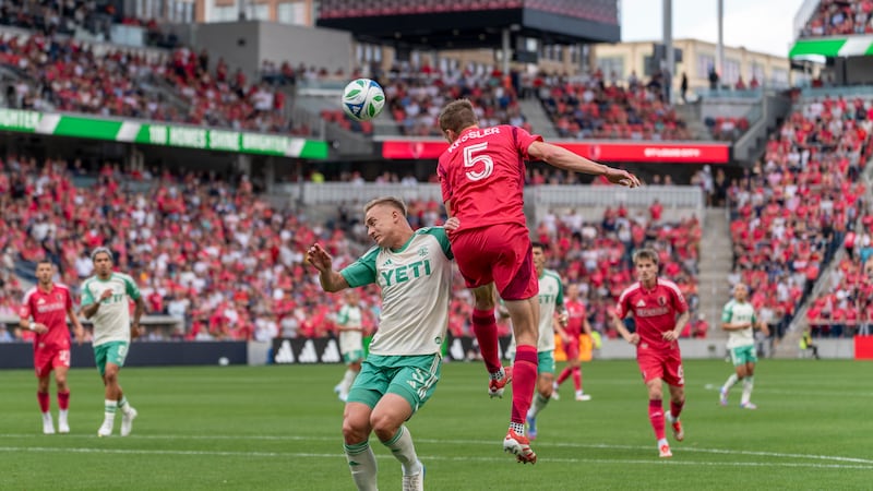 Center-back Henry Kessler goes up for a header against Austin FC.
