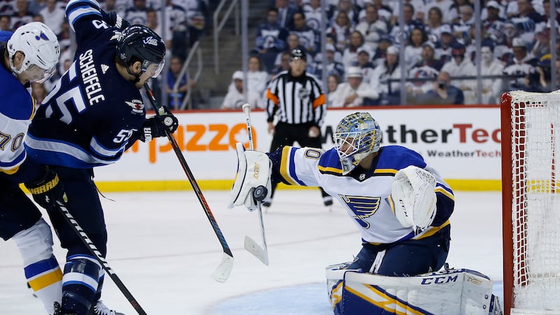Winnipeg Jets centre Mark Scheifele (55) is stopped St. Louis Blues goaltender Jordan...