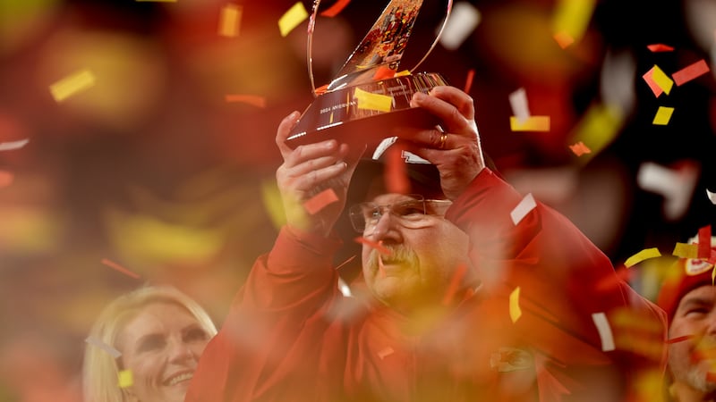 Kansas City Chiefs head coach Andy Reid holds the Lamar Hunt Trophy after the Chiefs defeated...