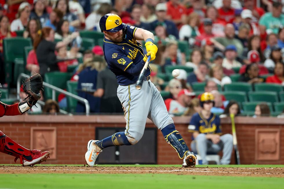 Milwaukee Brewers' Rhys Hoskins hits a single during the seventh inning against the St. Louis...