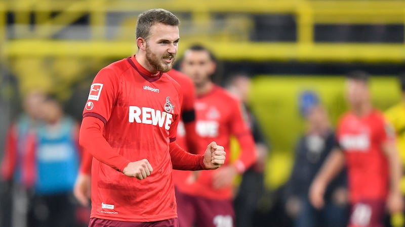 Cologne's Jannes Horn celebrates at the end of the German Bundesliga soccer match between...
