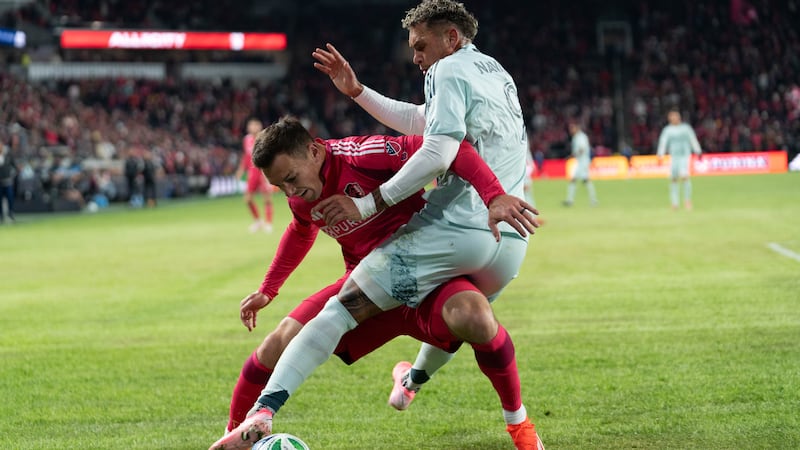 St. Louis CITY SC defender Kyle Hiebert battles against Colorado Rapids forward Rafael Navarro.