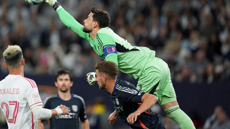 St. Louis City goalkeeper Roman Burki, above, punches a ball clear as he leaps over San Diego...