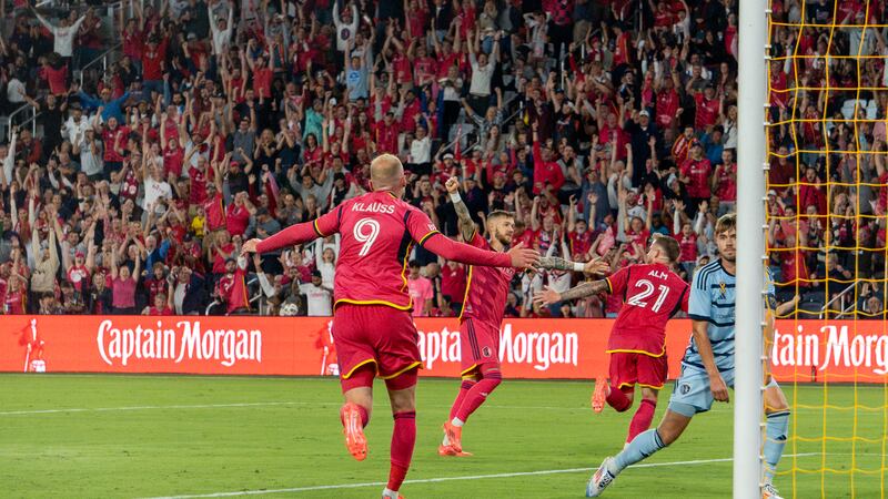 St. Louis' João Klauss runs to celebrate with Marcel Hartel and Rasmus Alm after CITY SC goes...