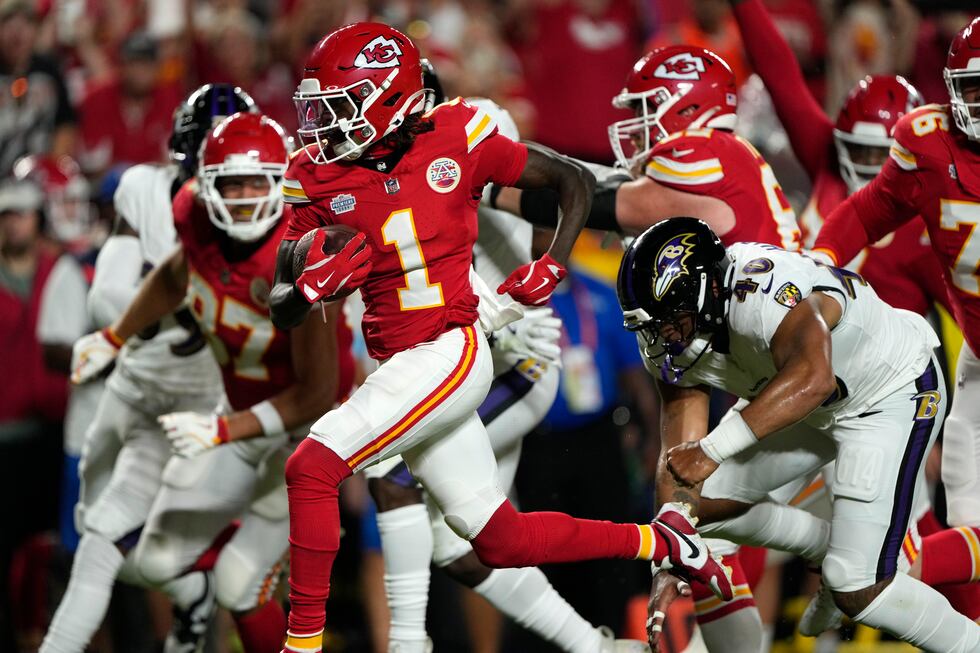 Kansas City Chiefs wide receiver Xavier Worthy (1) scores past Baltimore Ravens linebacker...