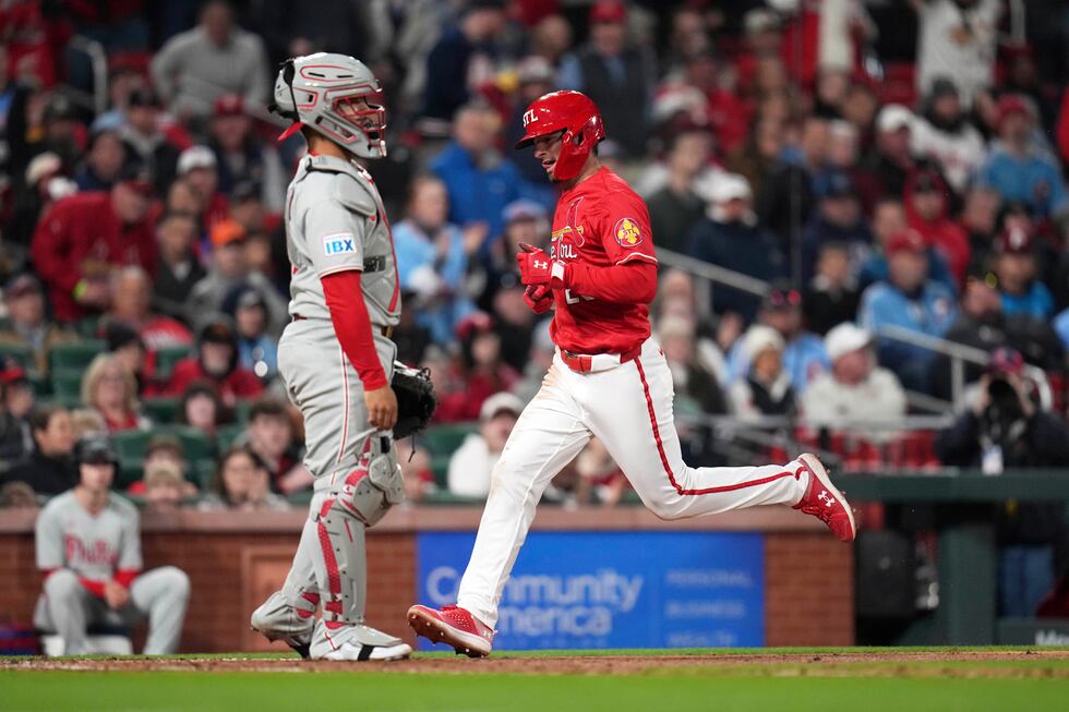 St. Louis Cardinals' Thomas Saggese, right, scores past Philadelphia Phillies catcher Rafael...