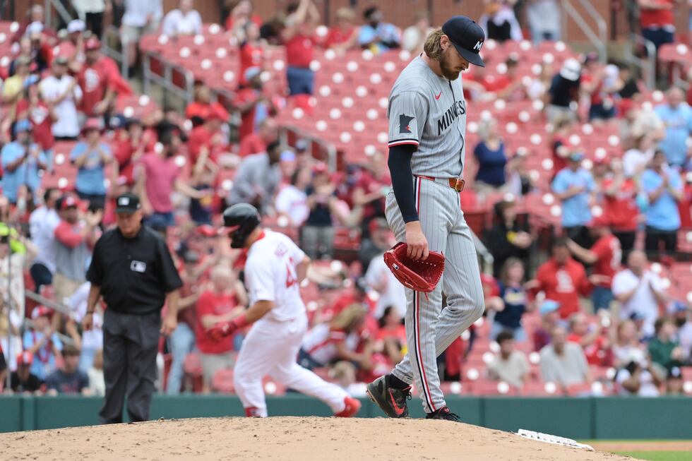 Minnesota Twins' Bailey Ober, right, looks on as St. Louis Cardinals' Pedro Pagés, center...
