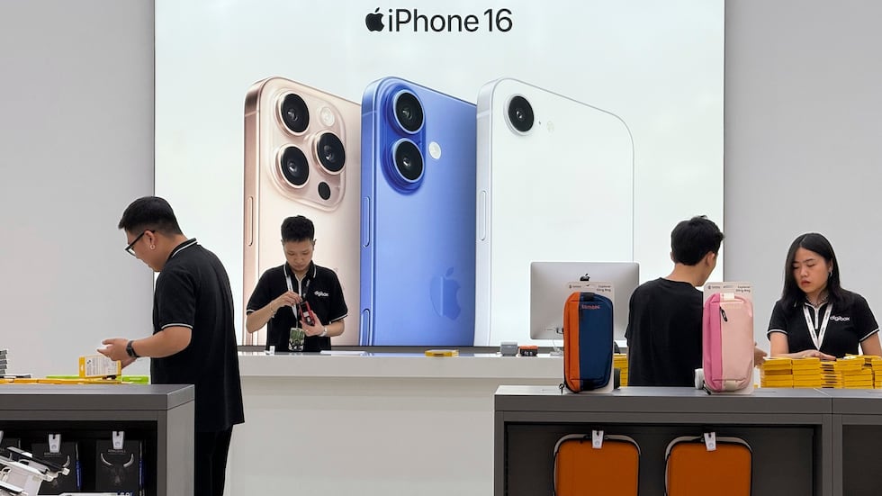 FILE - Sales staffs work at an Apple shop in Hanoi, Vietnam Thursday, April 10, 2025.