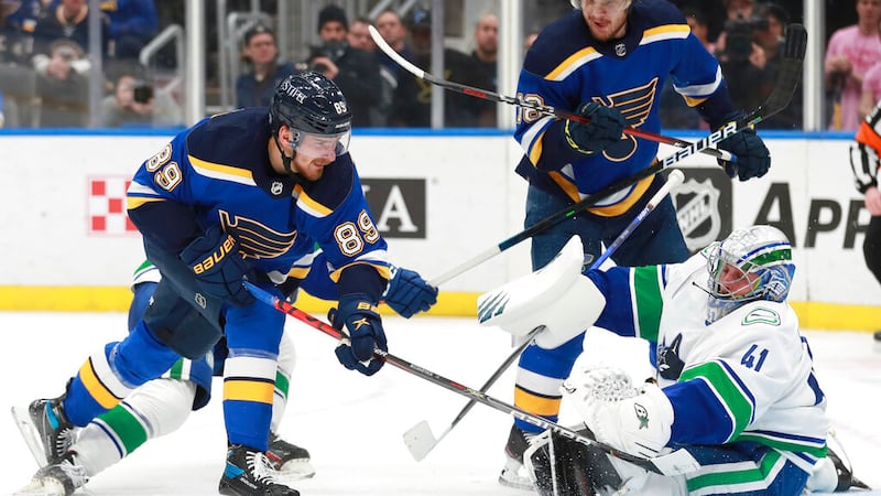 St. Louis Blues' Pavel Buchnevich (89) shoots the puck against Vancouver Canucks' Jaroslav...